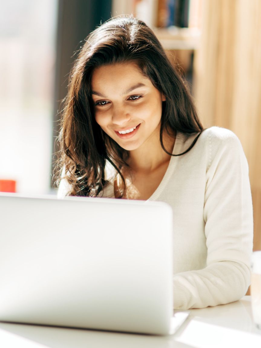 girl at table looking at financing offers for flooring